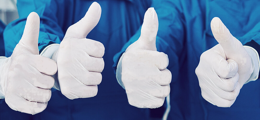 Thumbs up of surgical gloves made in Austria